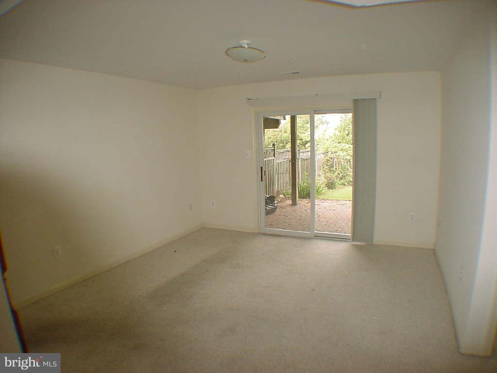 2430 Rippling Brook Road Frederick, MD 21701 - Photo 23 of 30 a view of an empty room with wooden floor and a window