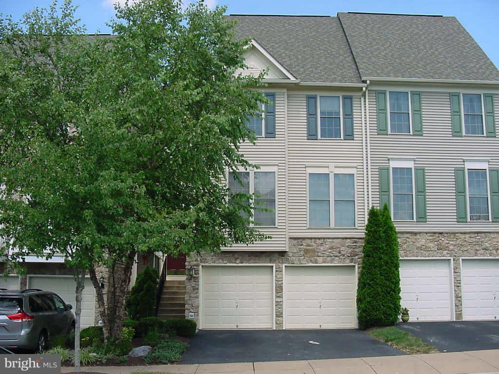 2430 Rippling Brook Road Frederick, MD 21701 - Photo 28 of 30 a front view of a house with a yard garage and outdoor seating