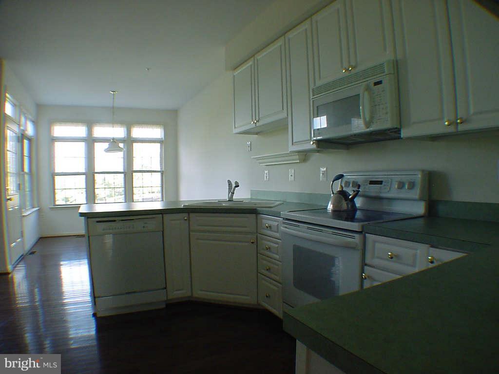 2430 Rippling Brook Road Frederick, MD 21701 - Photo 4 of 30 a kitchen with sink a microwave and cabinets