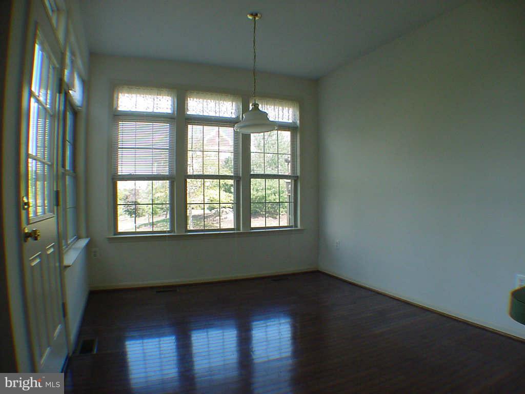 2430 Rippling Brook Road Frederick, MD 21701 - Photo 5 of 30 a view of an empty room with wooden floor and a window