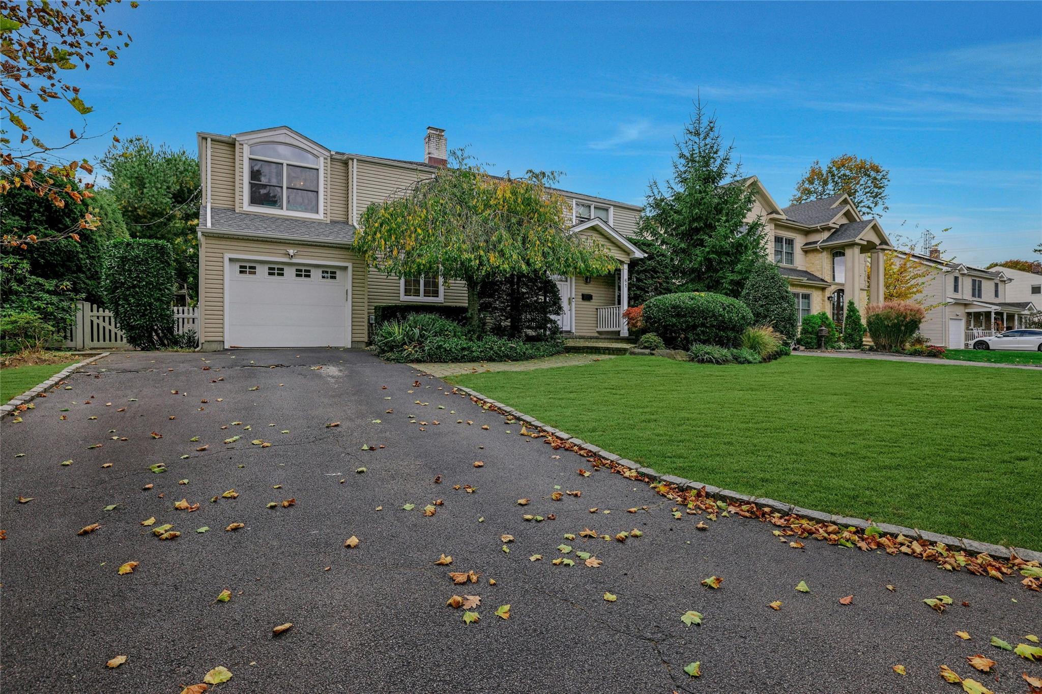 61 Argyle Road Albertson, NY 11507 - Photo 1 of 1 View of front of home with a garage and a front yard