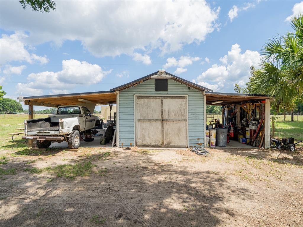4381 Northeast 105th Place Anthony, FL 32617 - Photo 39 of 49 a view of a garage with parked cars