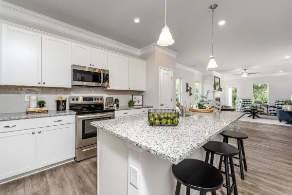 a kitchen with a table chairs and refrigerator