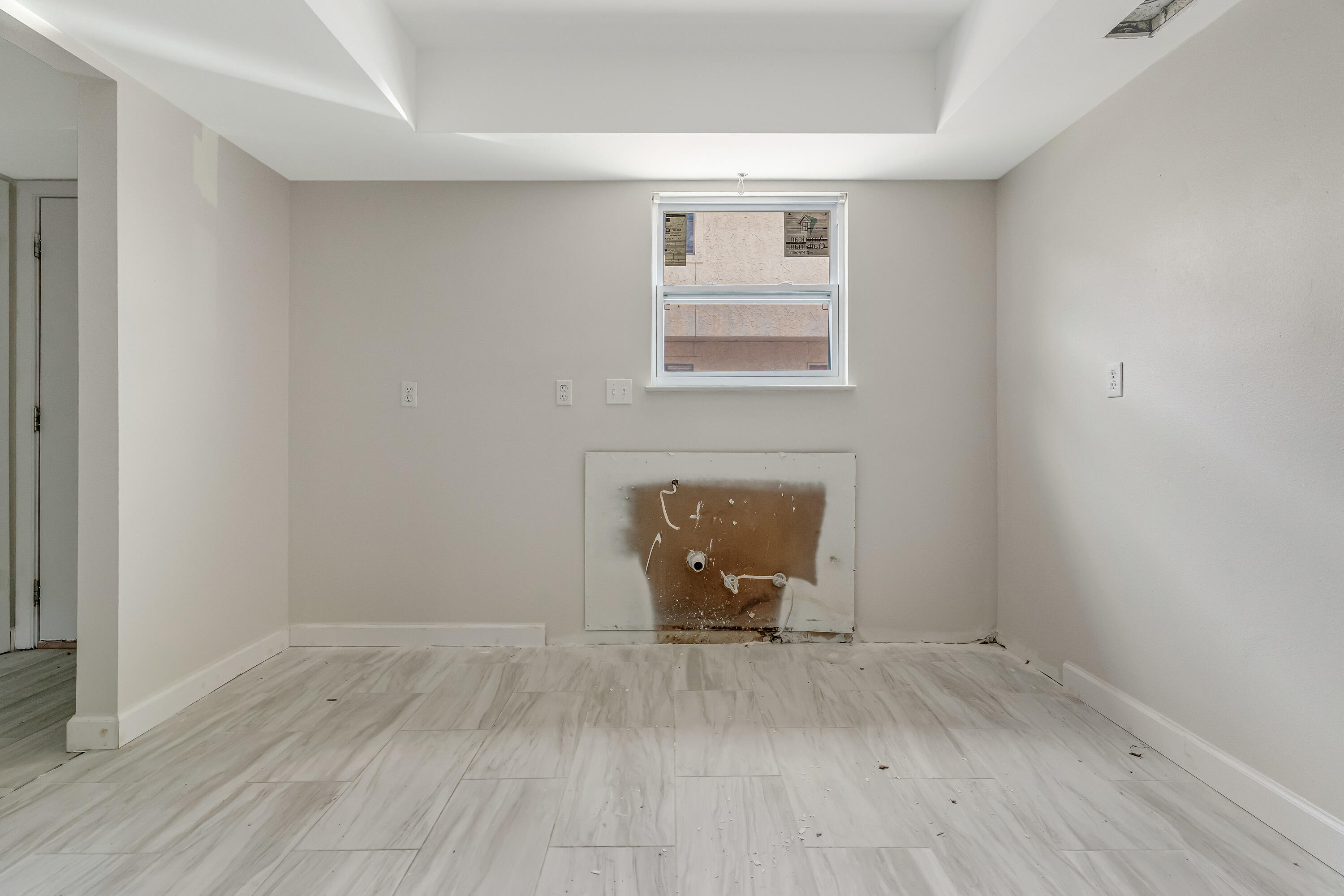 a view of empty room with wooden floor and fireplace