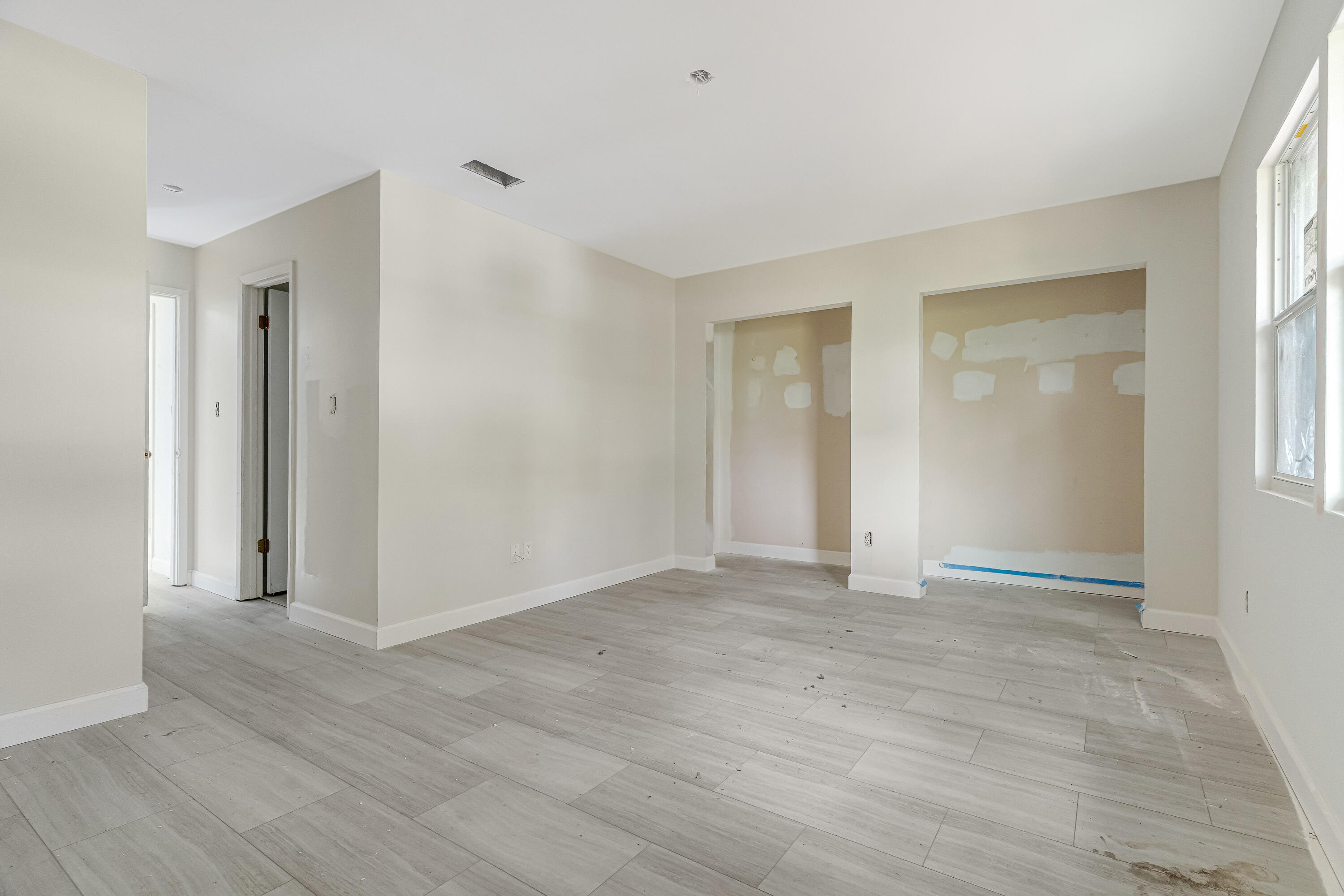 113 Cedar Avenue Southwest, Unit A Fort Walton Beach, FL 32548 - Photo 19 of 32 a view of an empty room with wooden floor and a window
