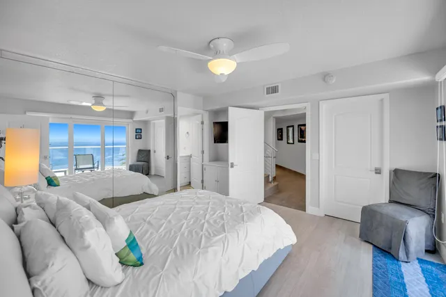 a bedroom with a large bed and a couch