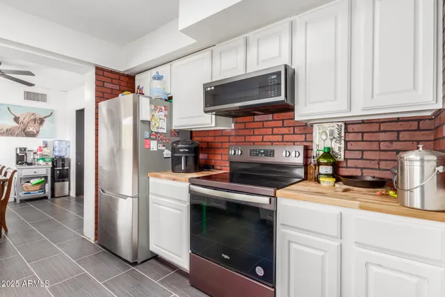 a kitchen with stainless steel appliances a stove microwave and refrigerator
