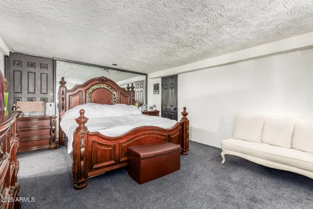 a bedroom with a bed and a couch