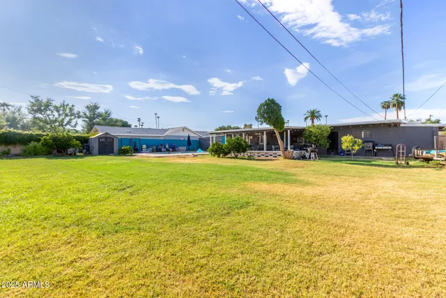 a swimming pool with outdoor seating and yard