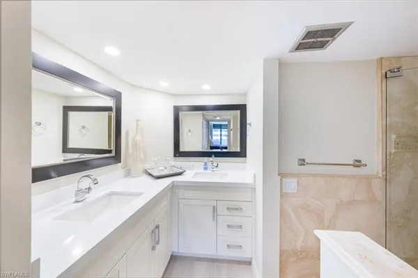 a bathroom with a sink double vanity and a mirror