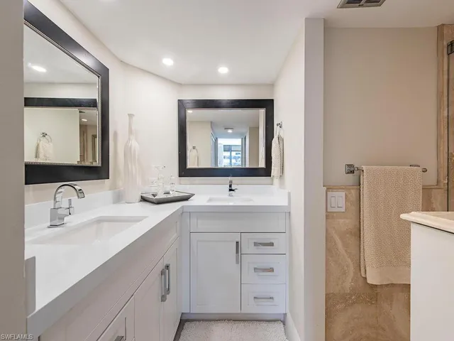 a bathroom with a double vanity sink mirror and toilet