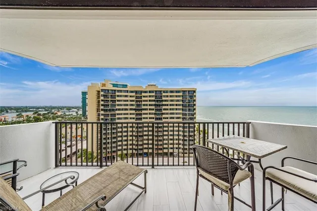 a view of a balcony with two chairs and a table