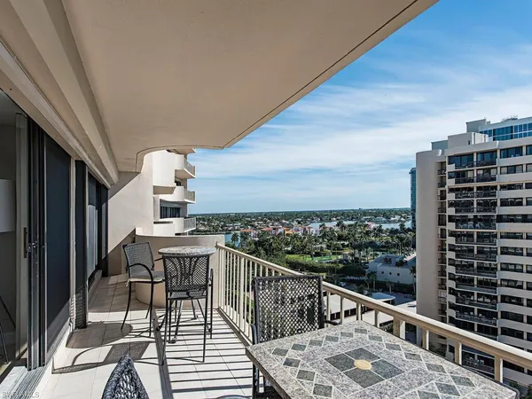 a view of balcony with wooden floor and seating