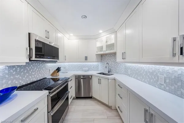 a kitchen with a sink stove and microwave