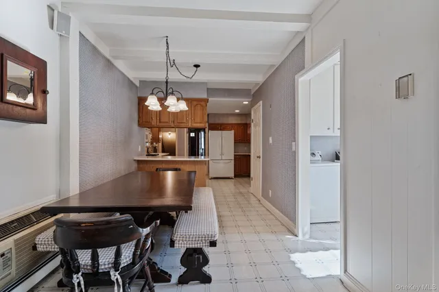 a view of a dining room with furniture and chandelier