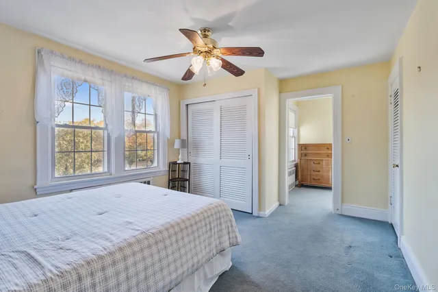 a spacious bedroom with a bed and a chandelier