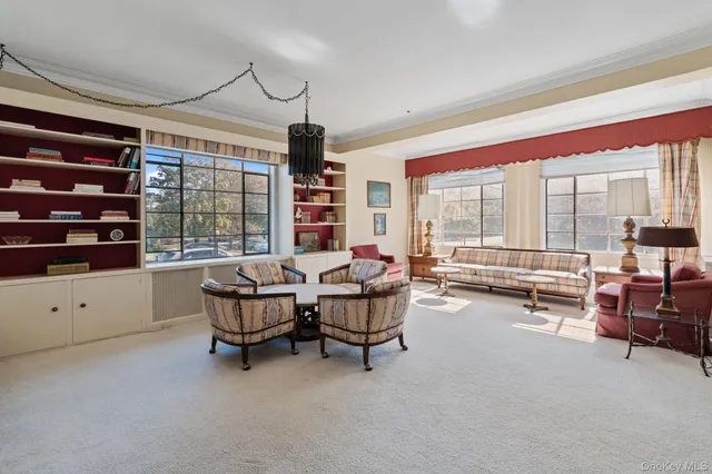 a living room with furniture and large windows