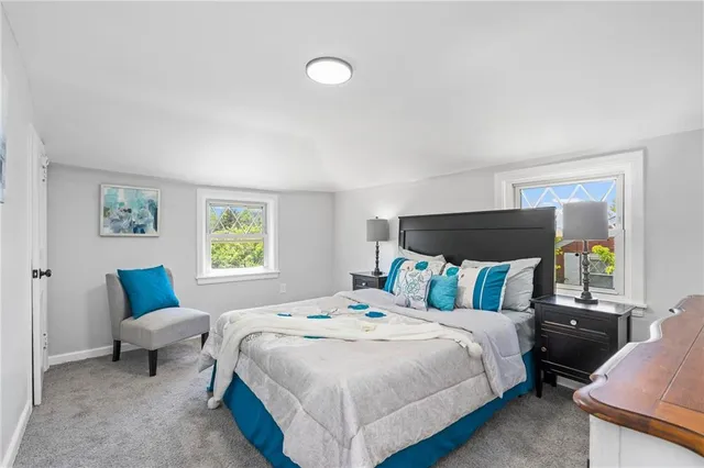 a bedroom with a bed and a couch