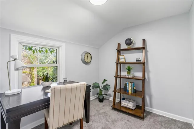 a view of a dining room with furniture and window