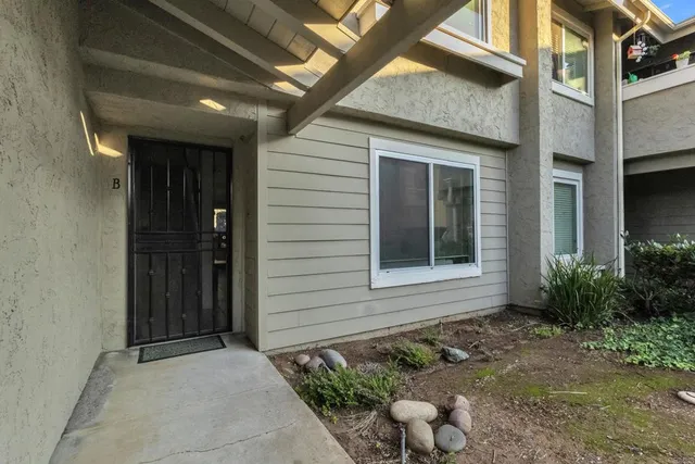 a view of a house with pool and a yard