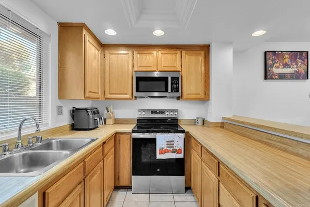 a kitchen with a sink a stove and cabinets
