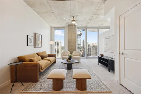 a living room with furniture and a chandelier