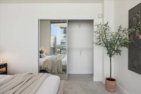 a bedroom with a bed and a potted plant