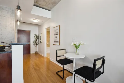 a view of a dining room with furniture and wooden floor