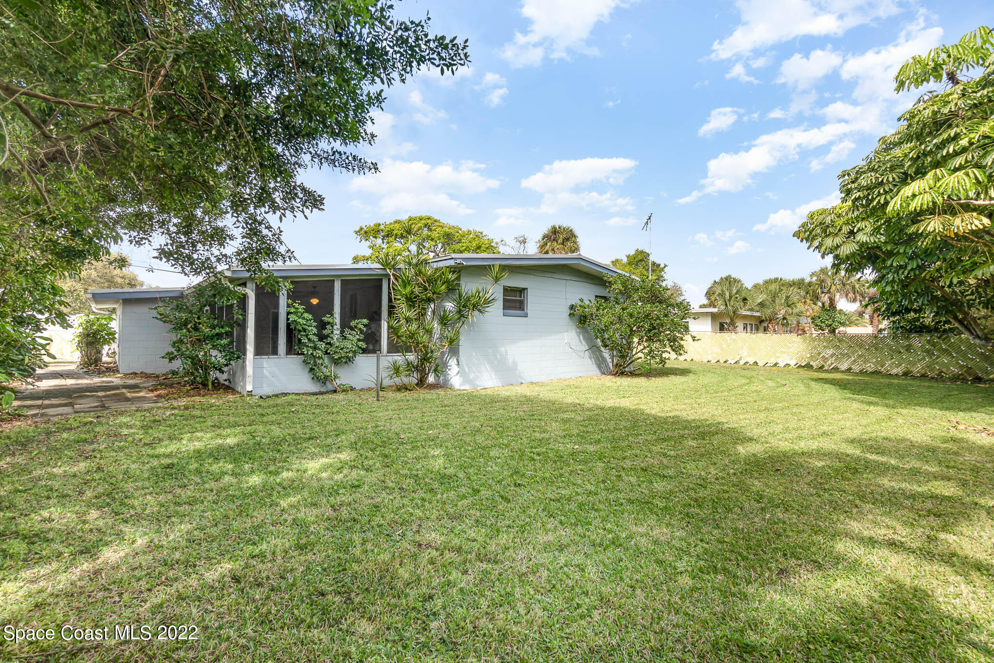 1024 Samar Road Cocoa Beach, FL 32931 - Photo 3 of 22 a front view of a house with a yard