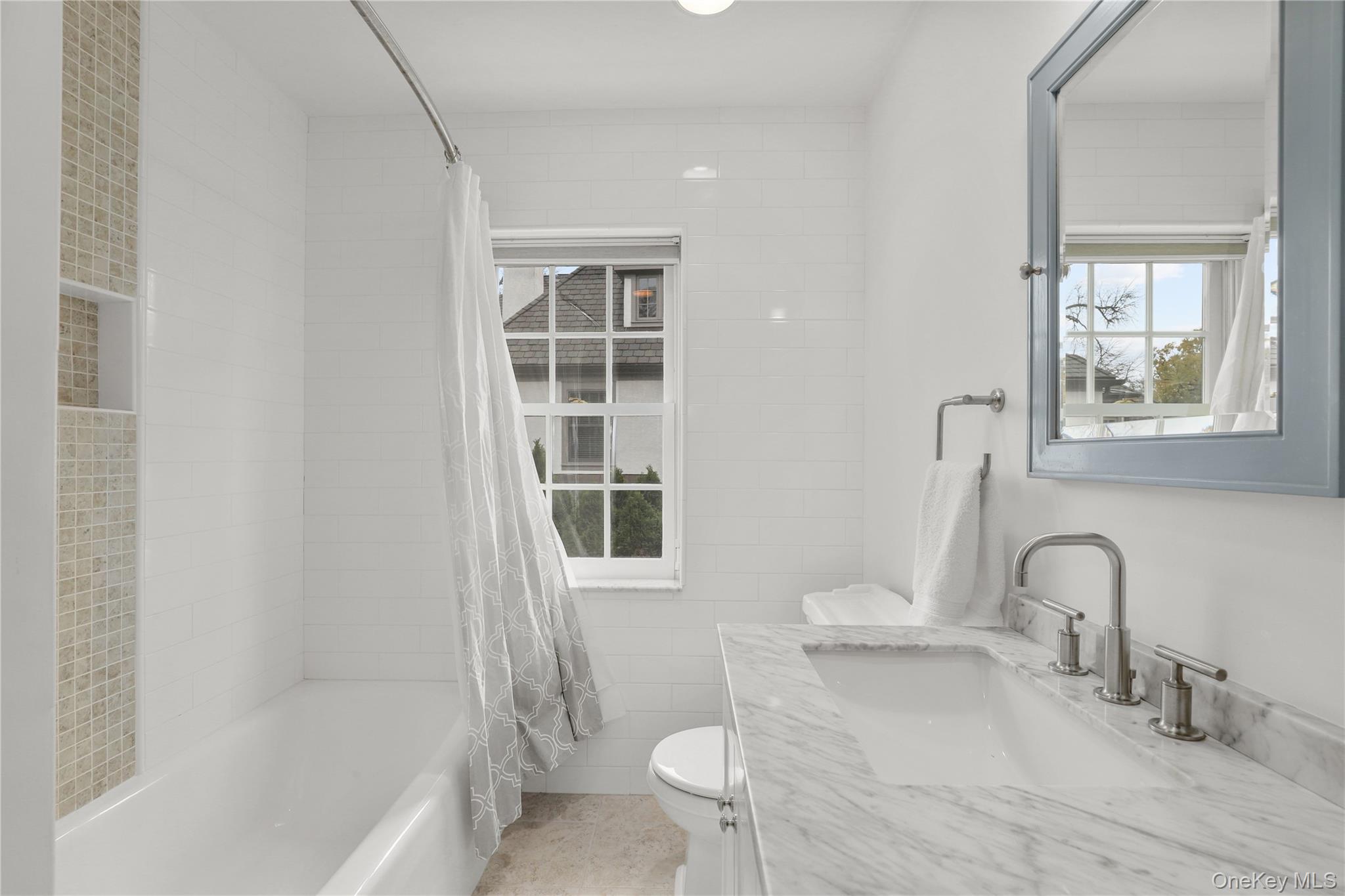 12 Sunnybrae Place Bronxville, NY 10708 - Photo 21 of 40 Full bathroom with vanity, shower / bath combination with curtain, tile walls, and light tile patterned floors