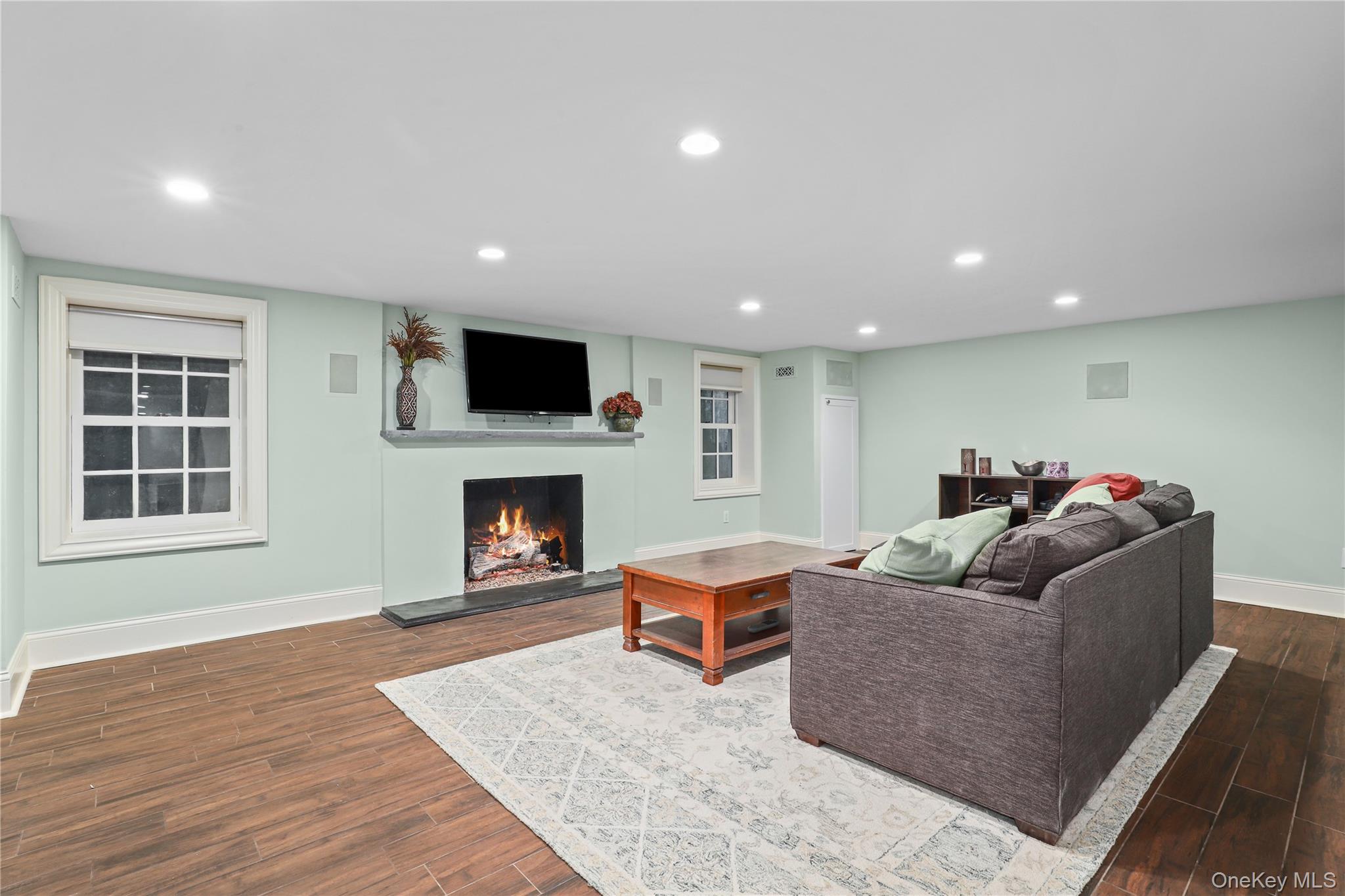 12 Sunnybrae Place Bronxville, NY 10708 - Photo 27 of 40 Recreation room with recessed lighting, a gas fireplace, and tile floors