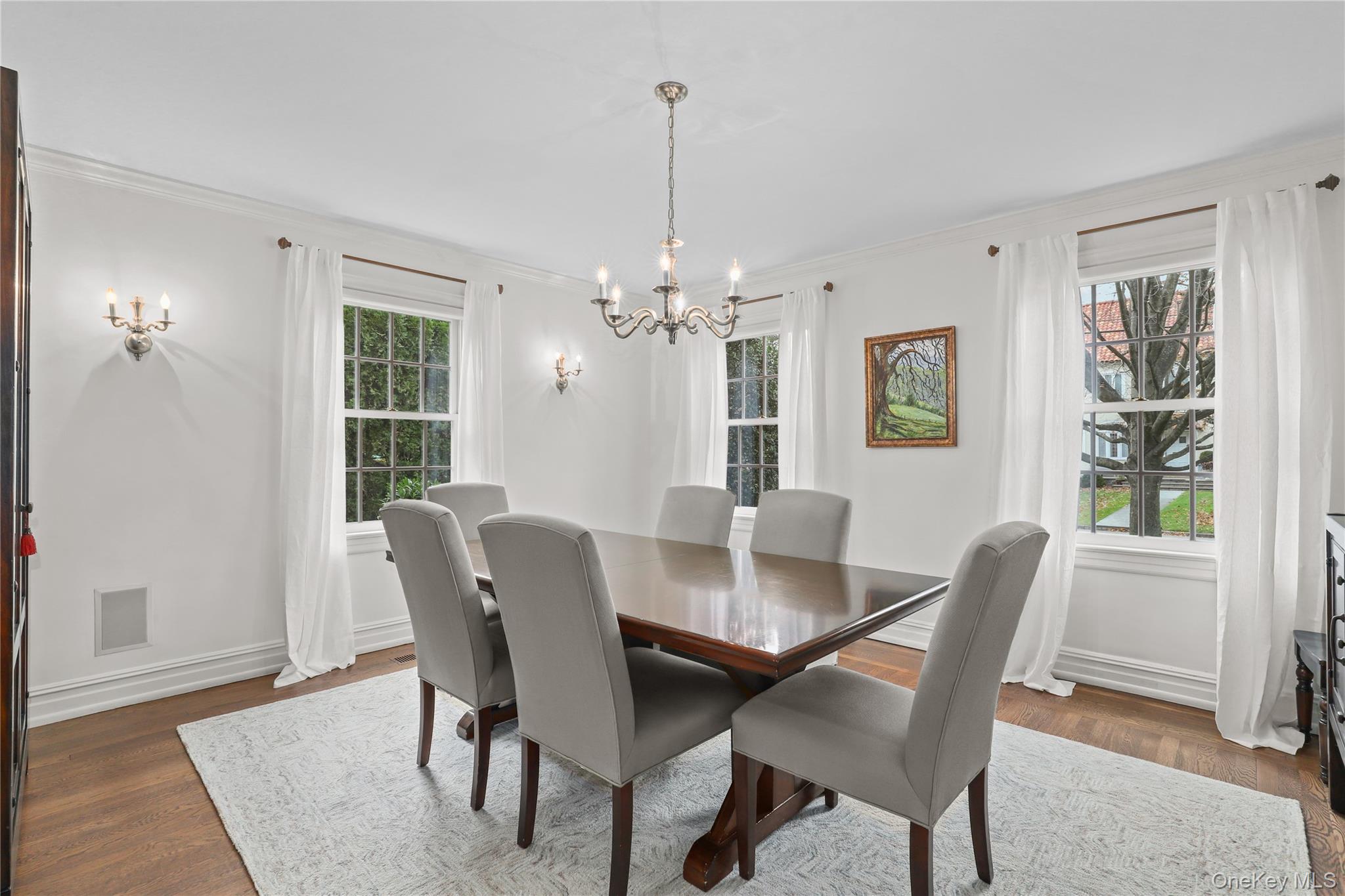 12 Sunnybrae Place Bronxville, NY 10708 - Photo 4 of 40 Dining area with ornamental molding, wood floors, and a chandelier