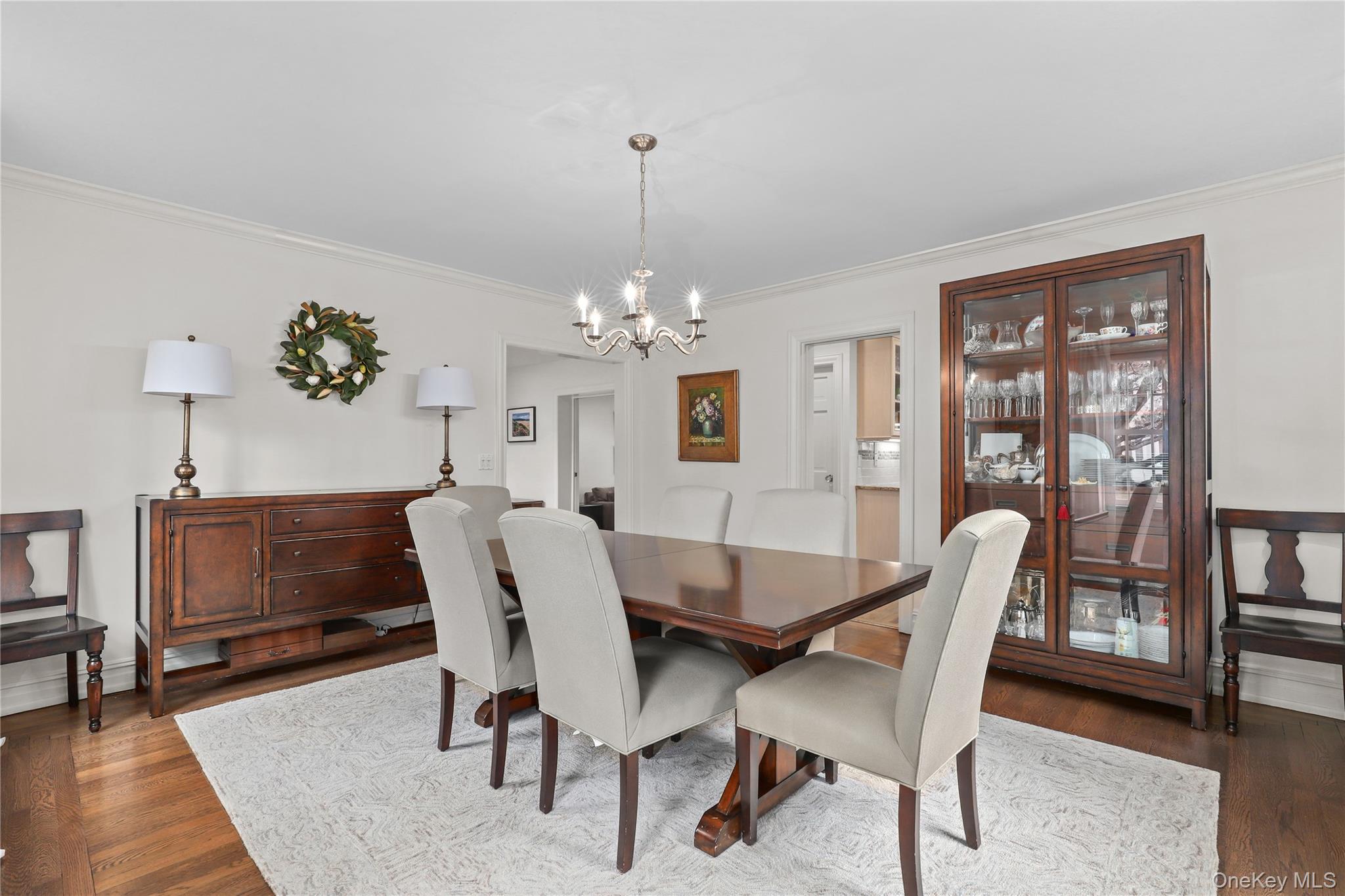 12 Sunnybrae Place Bronxville, NY 10708 - Photo 5 of 40 Dining space with wood flooring, ornamental molding, and a chandelier