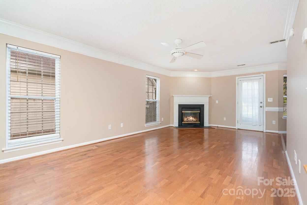 2218 Tree Ridge Road Indian Trail, NC 28079 - Photo 4 of 23 a view of an empty room with a fireplace and a window