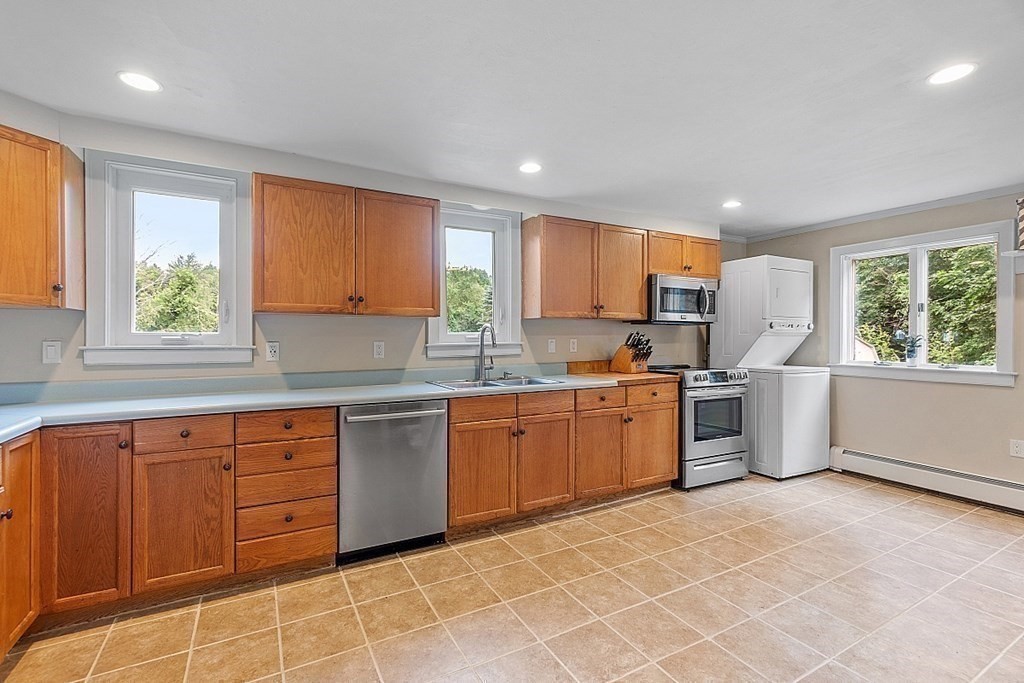 203 Stow Road Harvard, MA 01451 - Photo 13 of 42 a kitchen with a stove a sink and a refrigerator