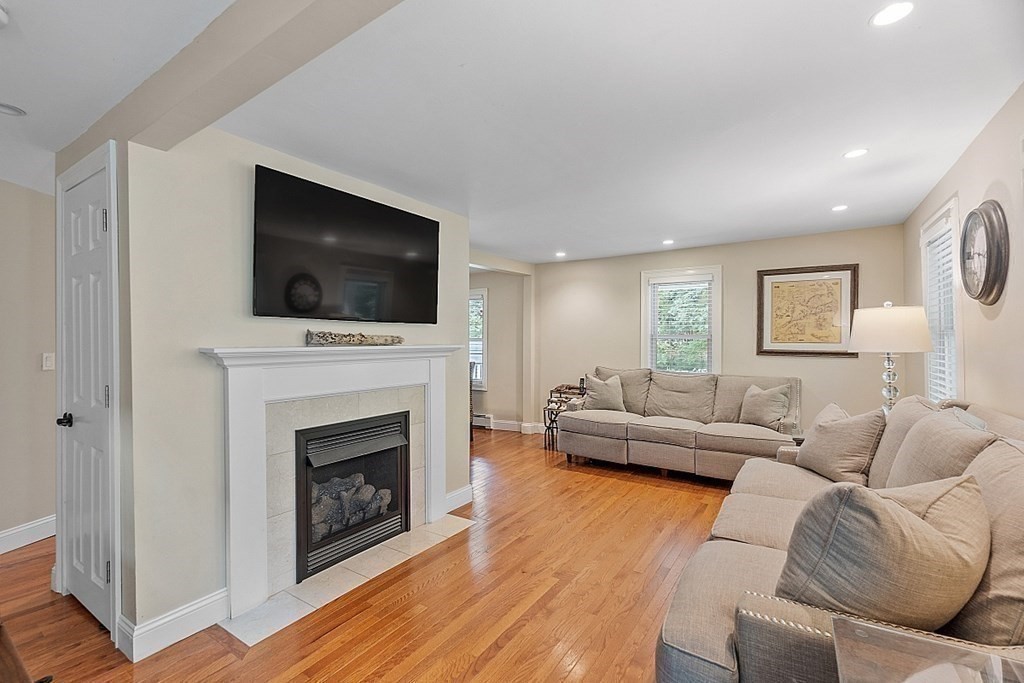 203 Stow Road Harvard, MA 01451 - Photo 8 of 42 a living room with furniture a fireplace and a flat screen tv
