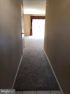 a view of hallway with wooden floor