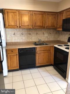 72 Shannon Road North Wales, PA 19454 - Photo 5 of 14 a kitchen with a sink a stove a microwave and cabinets