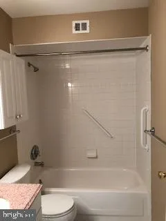 a bathroom with a bathtub and a toilet