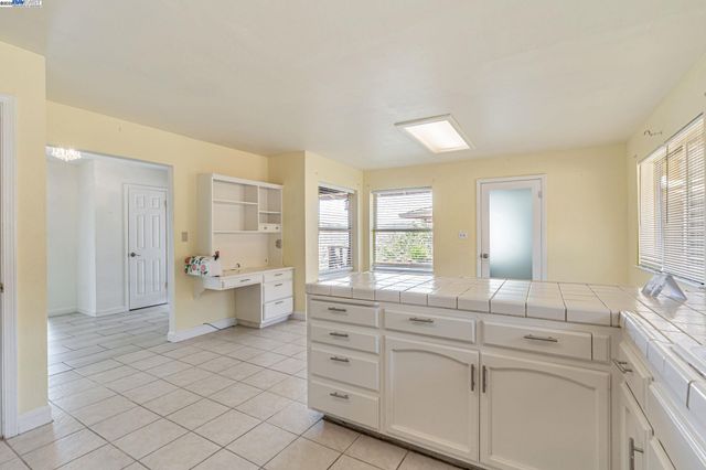 a spacious bathroom with a double vanity sink a mirror and a bathtub