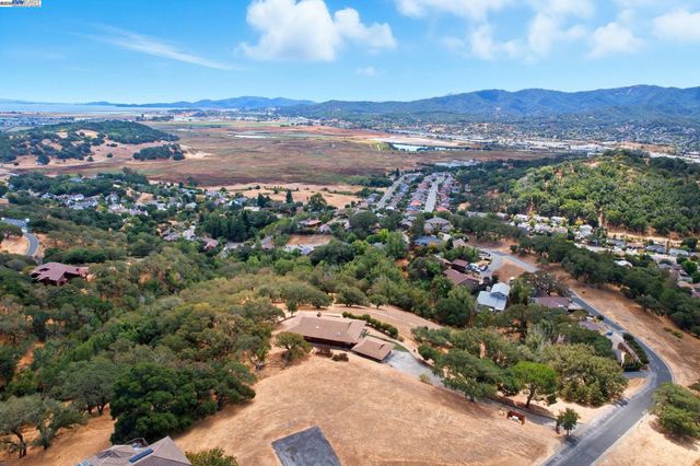an aerial view of a house with swimming pool and furniture
