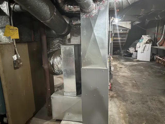 a backyard of a house with chairs and wooden fence