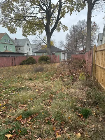 a city view with tall buildings and a yard