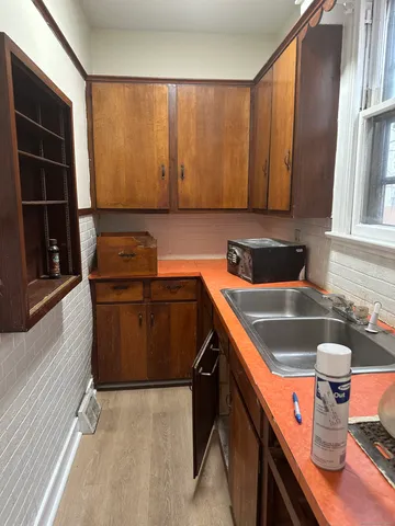 a kitchen that has a sink and a stove in it
