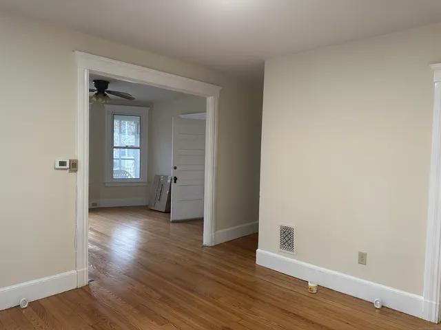 a view of wooden floor and windows in a room