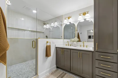 a bedroom with a bed mirror and window