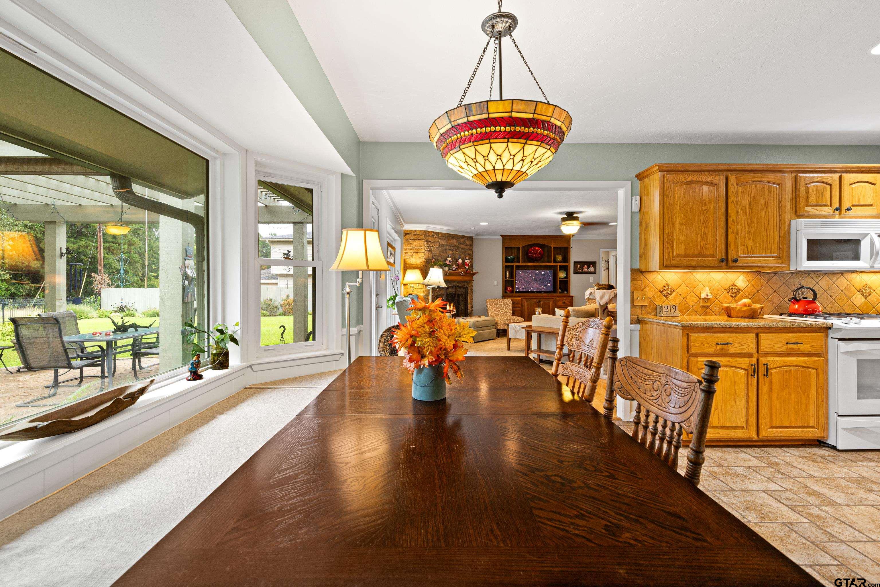 1610 Pinecrest Street Gilmer, TX 75644 - Photo 14 of 40 a view of a dining room with furniture a chandelier and wooden floor