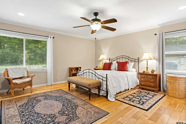 a bed room with a bed and dresser with mirror