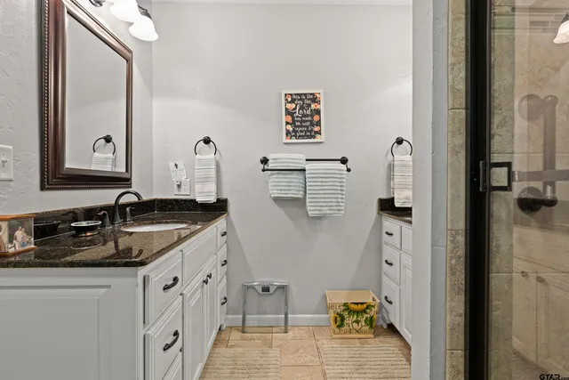 a kitchen with granite countertop a sink and a stove top oven