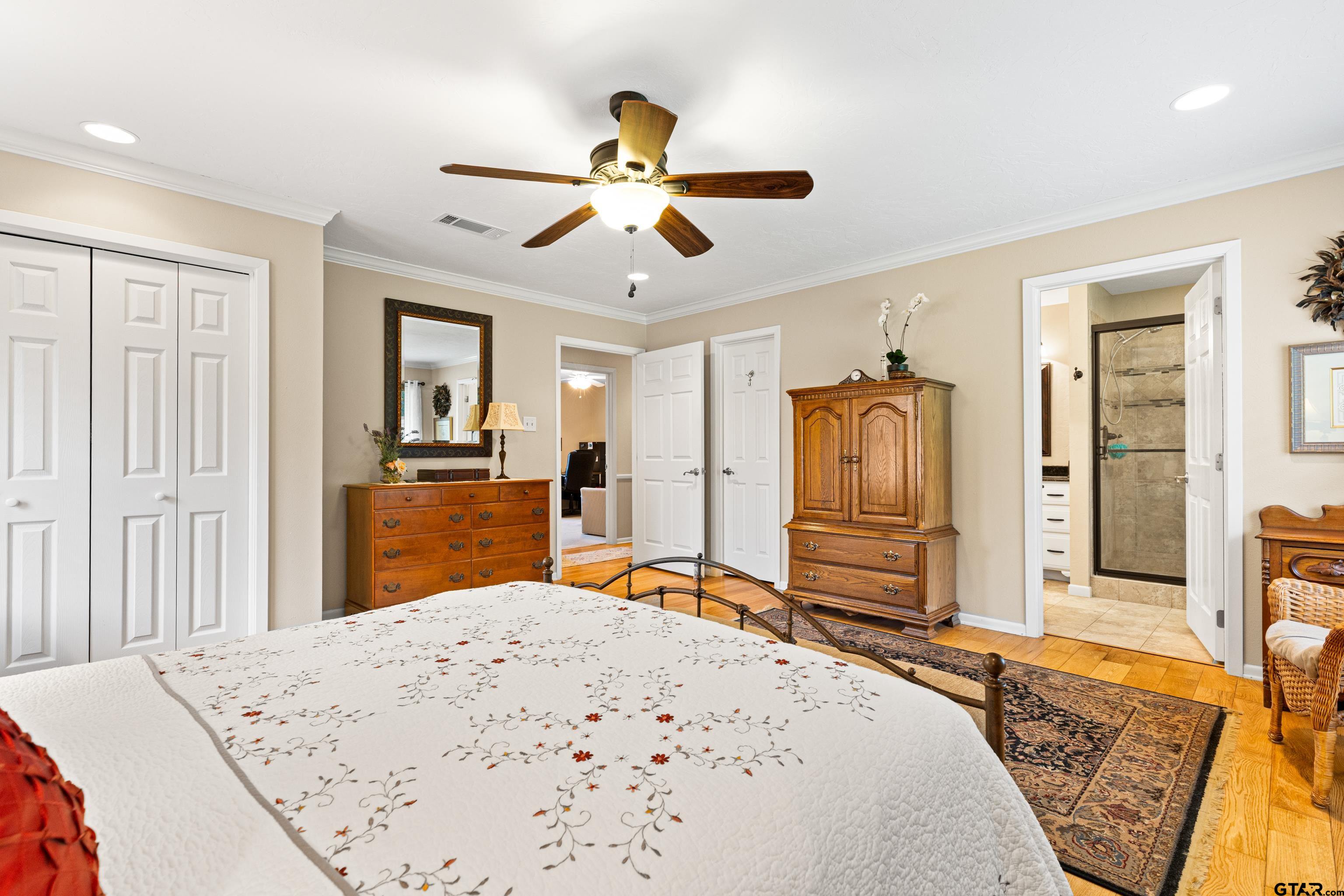 1610 Pinecrest Street Gilmer, TX 75644 - Photo 17 of 40 a bed room with a bed and dresser with mirror